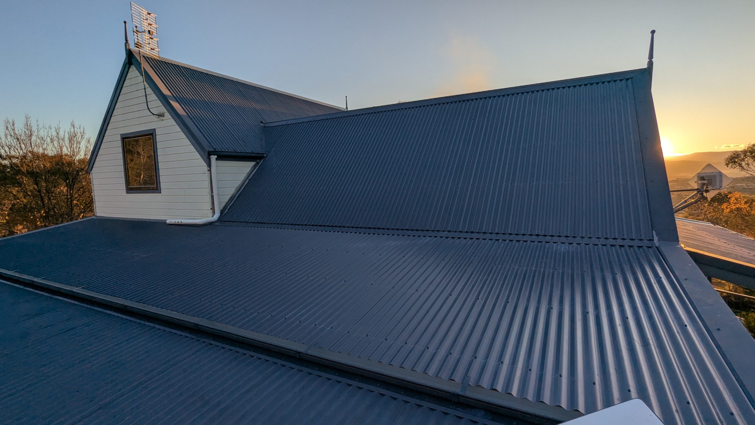 Complete uniform Colorbond re-roof on a Canberra home at golden hour