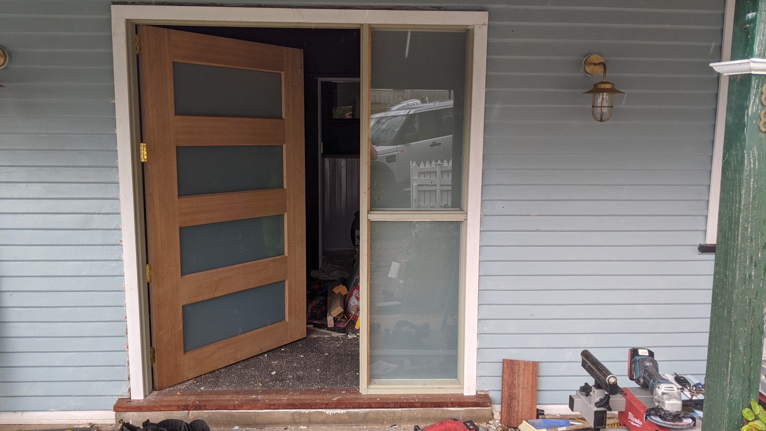Premium timber 4-panel pivot door installed on a weatherboard Canberra home