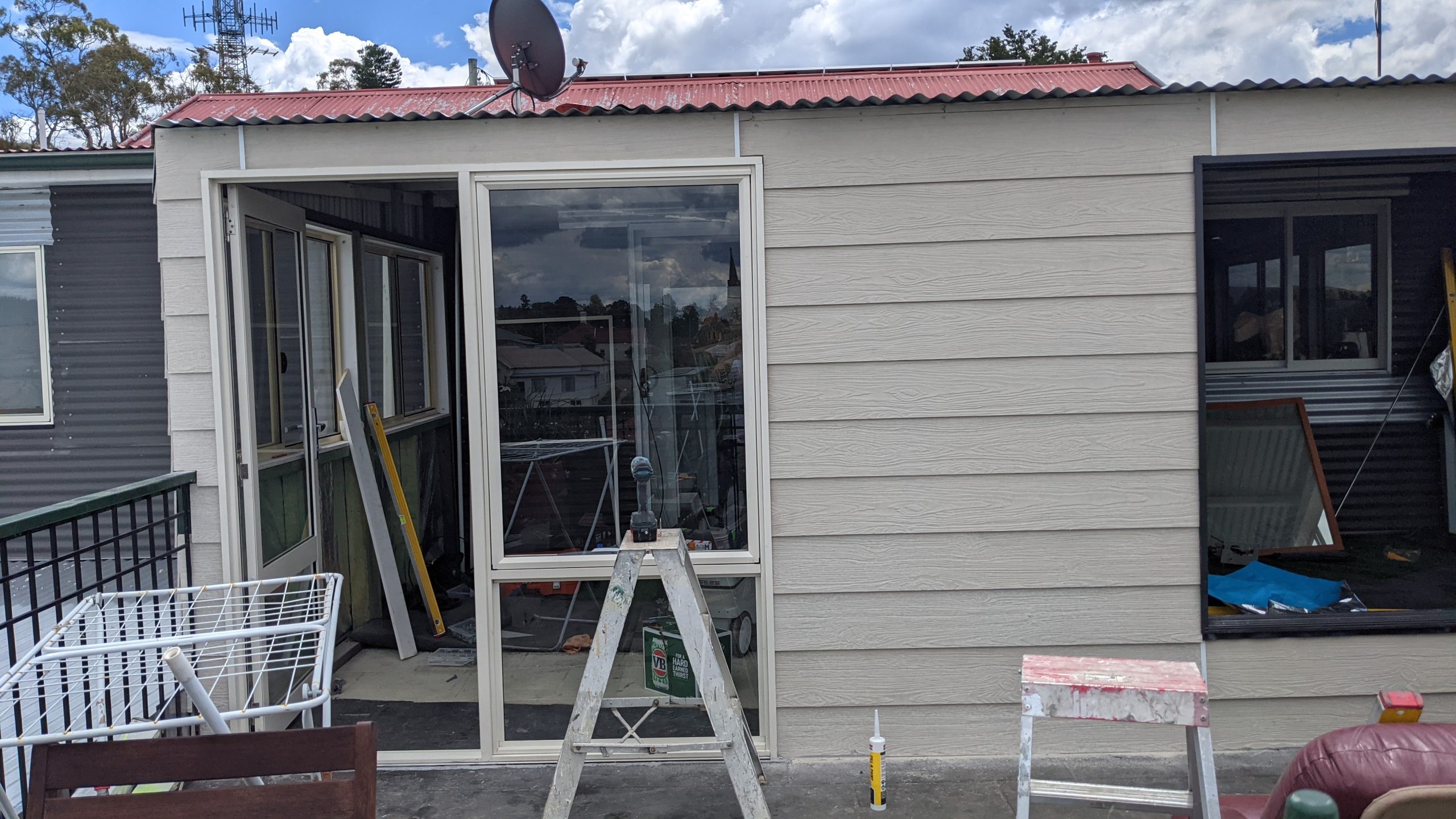 Home renovation with new red Colorbond roof and new windows in Yarralumla
