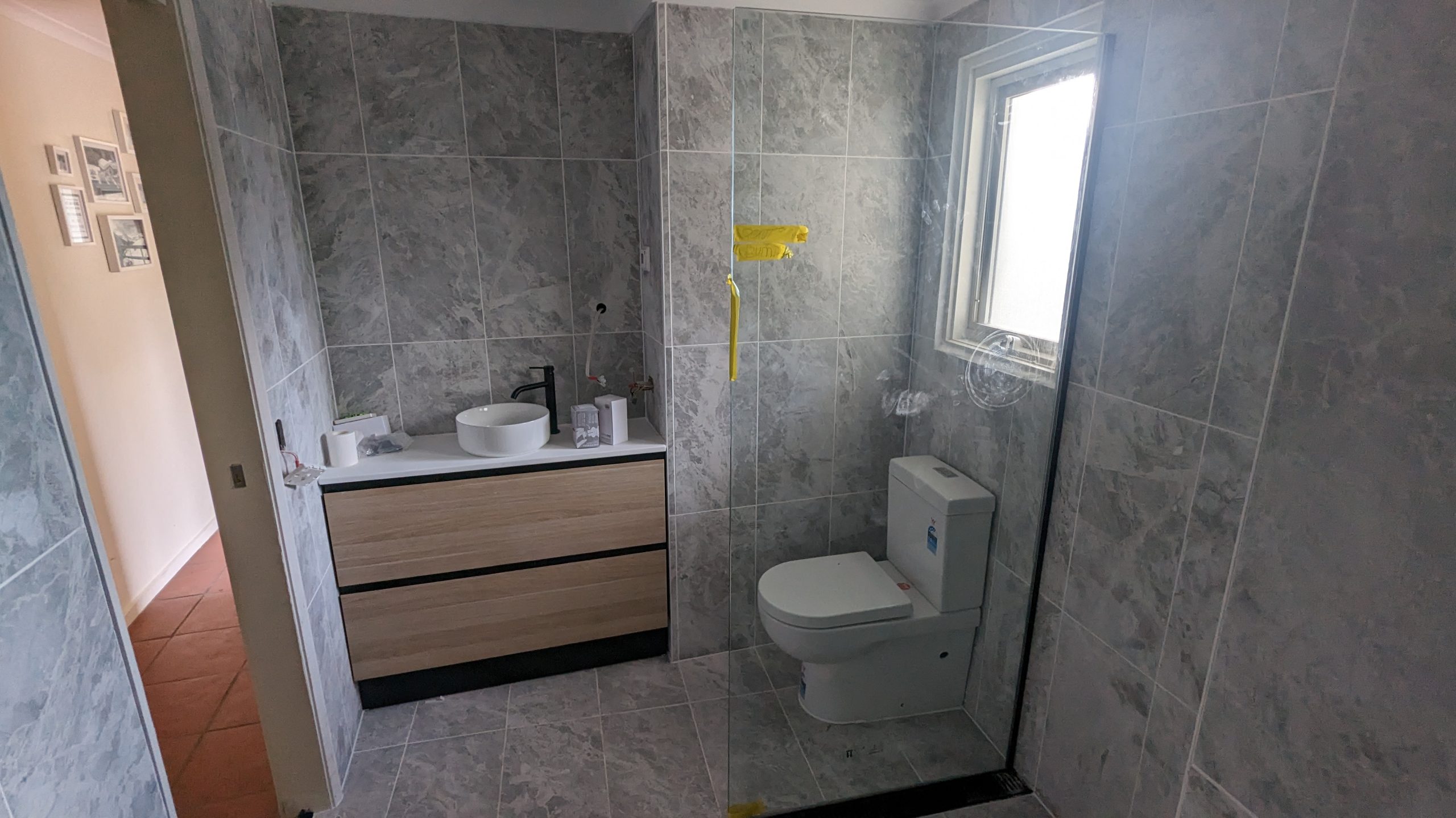Bathroom vanity with timber drawer carcase and brass tap in Yarralumla