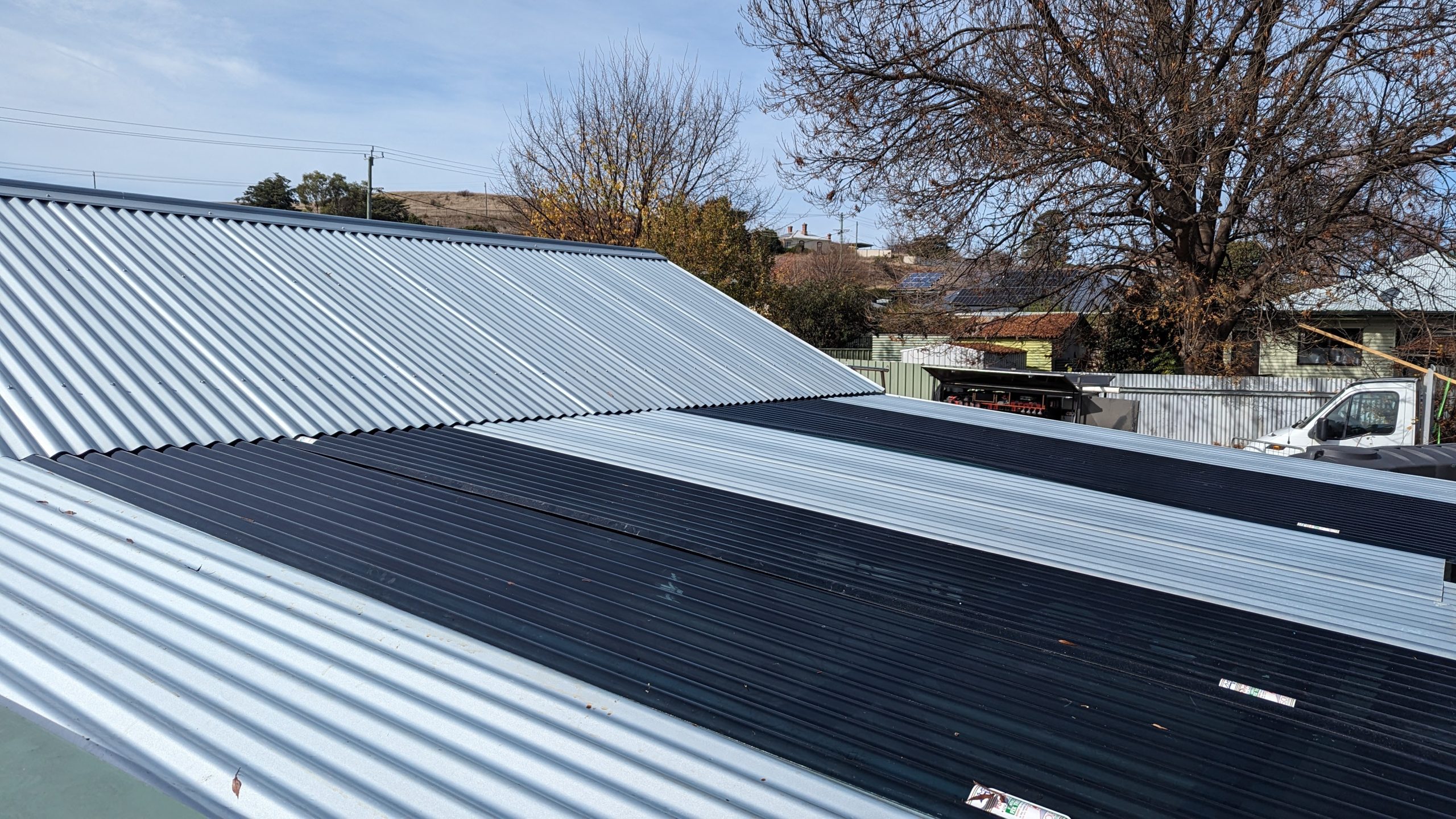 Clean two-tone Colorbond re-roof installation in Curtin
